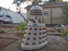 An Imperial Dalek action figure. A white Dalek (look you all know what a bloody Dalek looks like) with golden slats, bumps, gun arm, plunger arm, eyestalk, and tops of the lights on its head