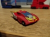 Micromaster Hot Rod in vehicle mode, a red futuristic (well futuristic for 1986) sports car with yellow flames on the hood, an exposed engine block, large side pipes, and a large yellow spoiler
