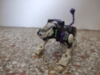 Energon Battle Ravage in beast mode, a generic mechanical big cat that is predomantly black with an off-white and silver head, lower limbs, and some purple highlights - including the tail which has a mace on the end. There are also some green details by the neck that look like they're meant to represent missiles