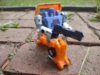 Kingdom Huffer in robot mode, wielding his gun and kneeling