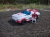 Legacy Minerva in car mode, with the Minerva Headmaster from the Legends God Ginrai giftset standing next to it.