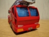 Legacy RID Optmus Prime in vehicle mode, a red firetruck with a license plate reading C-001