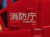 Legacy RID Optimus Prime in firetruck mode, from the front side with the kanji 消防庁 (Fire Disaster and Management Agency) and the word Cybertron tampographed on it