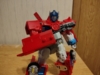 Legacy RID Optimus Prime in robot mode, wielding his small gun
