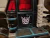 RID Scourge in vehicle mode, showing the Decepticon symbol tampographed on his cab doors.
